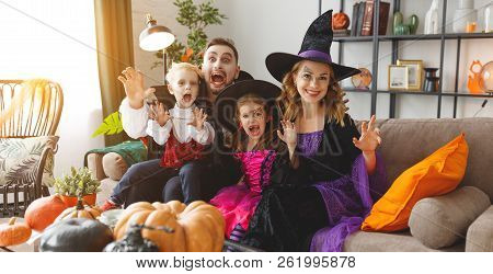 Happy Family Mother Father And Children In Costumes And Makeup On A Celebration Of Halloween