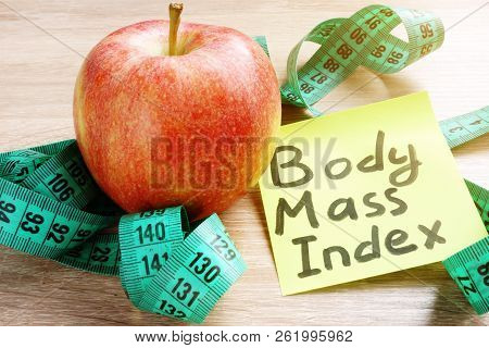 Body Mass Index Bmi Written On A Memo Stick And Apple.