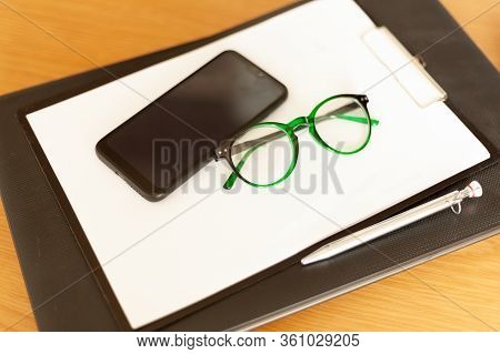 On A Laptop Are Paper Pen Glasses Glasses Smartphone, Mobile Office, Remote Work
