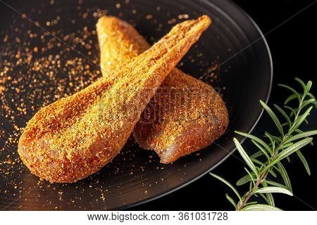Seasoned Chicken With Hot Sauce And A Sprig Of Rosemary