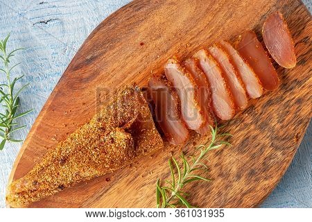 Seasoned Chicken With Hot Sauce And A Sprig Of Rosemary