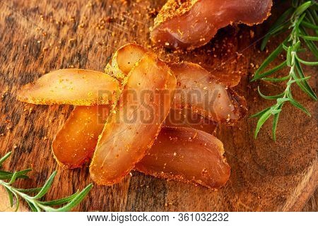 Seasoned Chicken With Hot Sauce And A Sprig Of Rosemary