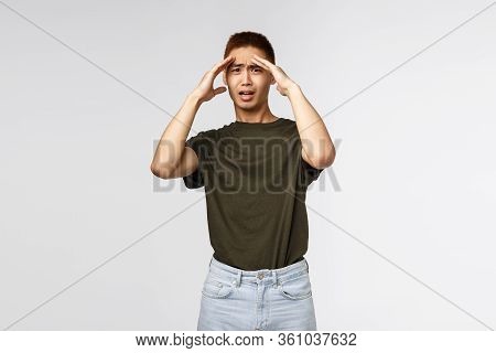 Gosh Its Insane. Portrait Of Shocked And Concerned Young Asian Man Got In Trouble, Touch Forehead Gr
