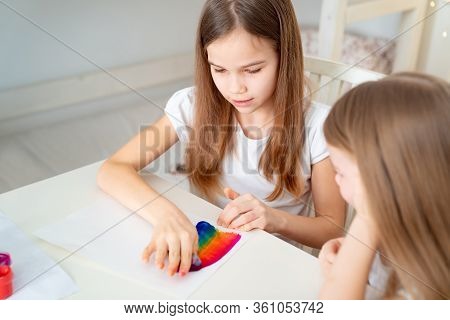 Sisters Drawing With A Sponge On A White Sheet Rainbow. Stay At Home. Flashmob Chasetherainbow.