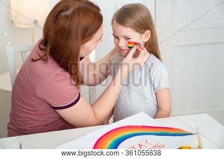 Redhead Mom Draws The Blonde Daughter Of The Rainbow On Her Cheek. Stay Home. Flashmob Chasetherainb