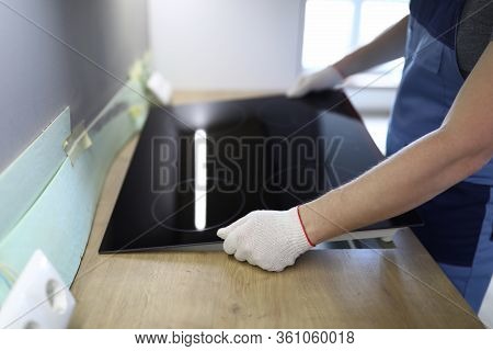 Close-up Of Professional Handyman Setting Cookstove. Male In Protective White Gloves On Kitchen. Mov