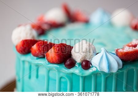 Cake Turquoise And Blue With Strawberries, Meringue And Candies.