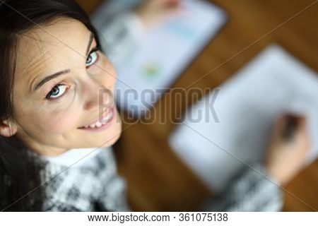 Top View Of Smiling Female Signing Contract In Office. Happy Brunette Company Worker In Presentable 
