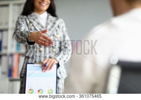 Close-up Of Cheerful Employee Extend Hand For Handshaking. Woman In Luxury Presentable Suit. Clipboa