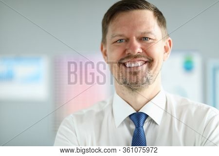 Close-up Of Smiling Middle-aged Businessman Wearing Presentable Suit. Copy Space In Left Side. Macro