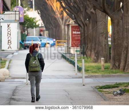 Split,croatia April 2020
Red Headed Girl As Seen From Behind Walking On The Street Wearing A Face Ma