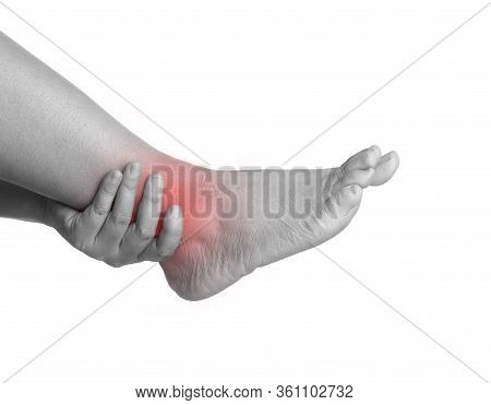 Woman With Ankle Pain Using Hand Holding Leg And Massaging Painful Her. Discomfort Around The Ankle,