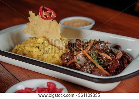 Peruvian Food Lomo Saltado :a Salted Beef With Tomatoes, Onion, Fried Potatoes And Rice. Risotto