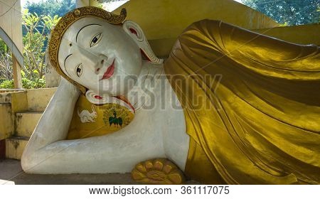 Mandalay, Myanmar - January 14, 2020: Reclining buddha at buddhist monastery Manijota Dhamma Yeiktha in Amarapura