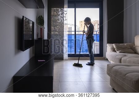 Child Sweeping Floor In Living Room At Home. Housekeeping And Household