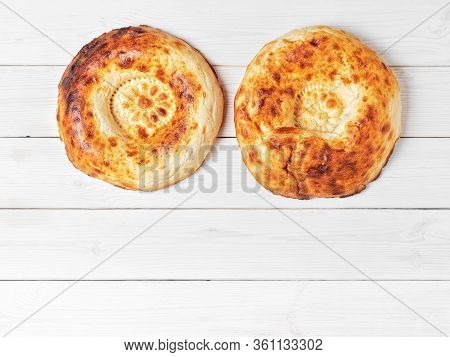 Tasty Fresh Round Tandoor Bread On A White Wooden Background. Flat Lay For Banner With Copy Space Fo