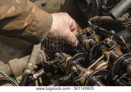 Checking The Thermal Clearances Of The Intake Valves Of The Gasoline Engine. An Elderly Mechanic Che