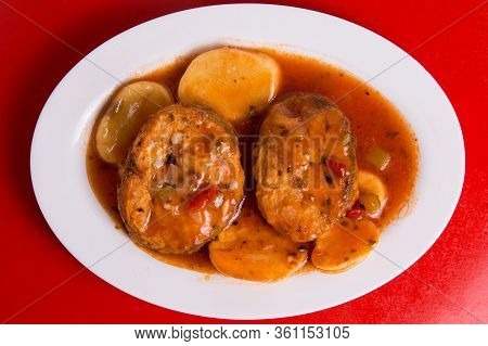 Cod Or Pollack Cooked In Tomato And Thyme Sauce.
