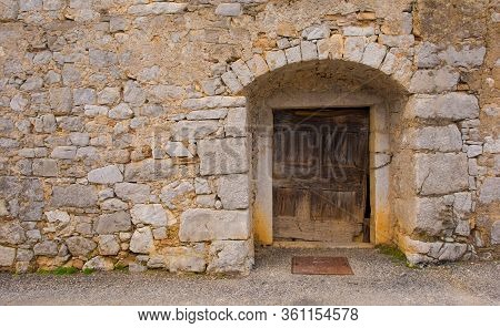 An Old Wooden Door In A Derelict Building In The Historic Hill Village Of Stanjel In The Komen Munic