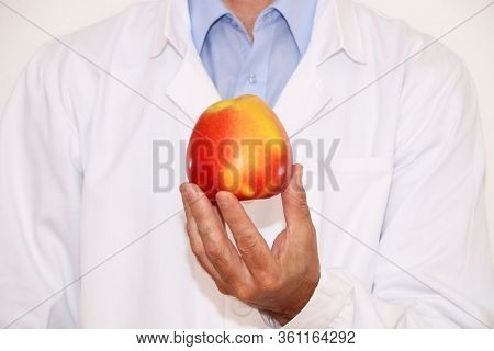 The Doctor Is Holding Vegetables And Fruits For Proper Wholesome Nutrition
