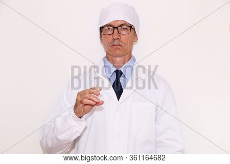 Concept Covid-19 - Doctor Holds A Syringe For Vaccination