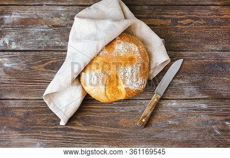 One Bun Of Freshly Baked Yeastless Bread Wooden Rustic Background. The Concept Of Home-made Diet Bak