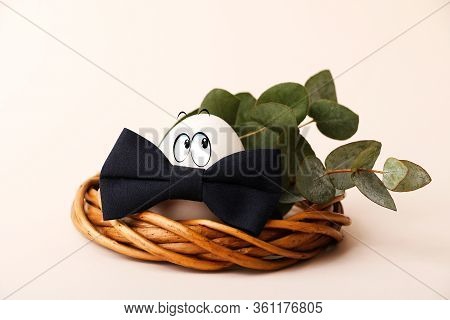 Funny Smiling Easter Egg In The Nst With Eucalyptus Branch On The Back.copy Space For Text Or Design