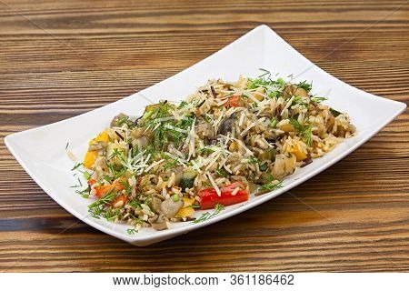 Stewed Vegetables With Rice On A Plate On A Wooden Background