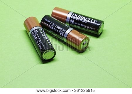 Umea, Norrland Sweden - March 25, 2020: Three Aa Batteries On Green Background