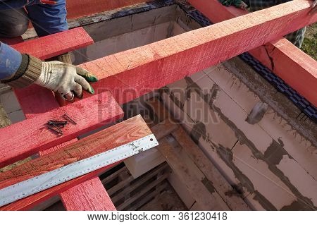 Workers Mount Wooden Beams For The Roof.