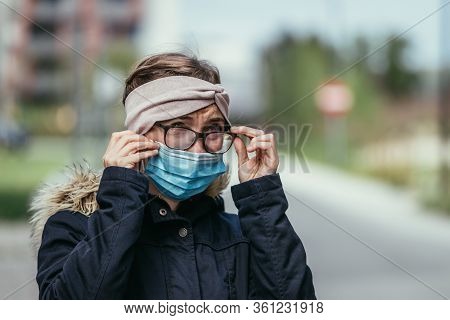 Woman With Facemask And Tarnished Glasses, Corona Concept