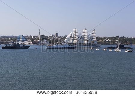 Sevastopol, Crimea, Russia - July 28, 2019: Khersones Sailboat Passes Near The Parade System Of Wars