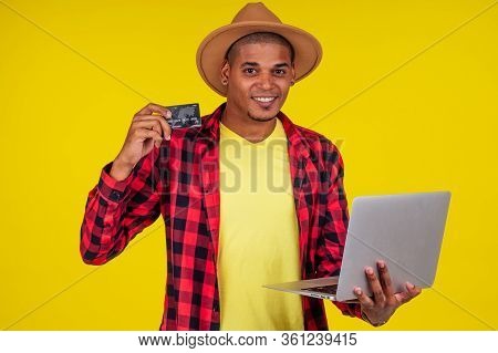 Afro Brazilian Man With Credit Card In Stusio On Yellow Background.farmer Taking A Loan In A Bank Fo