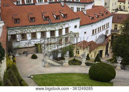 Prague, Czech Republic. March, 31, 2014. The Vrtba Garden. White Wall Covered With Vine, Red Roof Ti