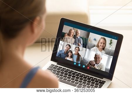 Woman Communicating With Family Using Laptop And Videoconference Application