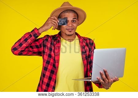 Afro Brazilian Man With Credit Card In Stusio On Yellow Background.farmer Taking A Loan In A Bank Fo