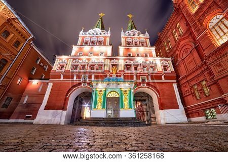 Evening Photo Of The Resurrection Gate In Moscow With Illuminated Buildings Against Moving Clouds Sk