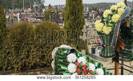 A Wreath Of Arificial Flowers On A New Burial. Coronavirus Concept.
