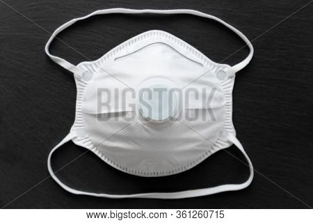 Facial Medical Maska For Virus Protection On A Black Textured Background