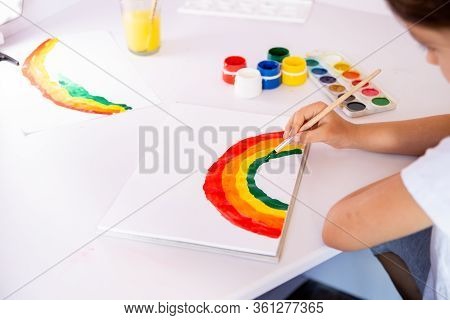 Stay At Home Due Coronavirus Pandemic Concept. Little Girl Paints A Rainbow On Stay At Home Poster. 