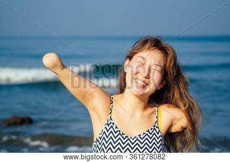 Happy Asian Armless Woman Smilimg At The Tropical Beach