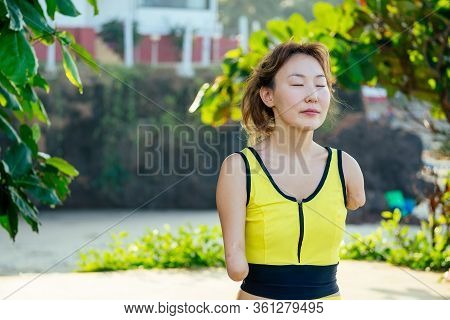 Happy Asian Armless Woman Doing Meditation Yoga At The Tropical Beach