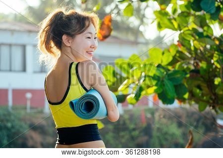 Happy Asian Armless Woman Warming Up Before Swimming At The Tropical Beach