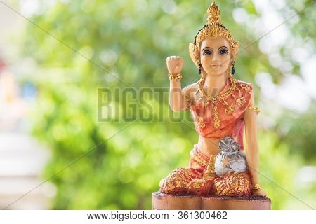 A Beautiful Woman Statue Sitting Beckoning Happy Lot In With Green Nature Background, Nang Kwak Is A