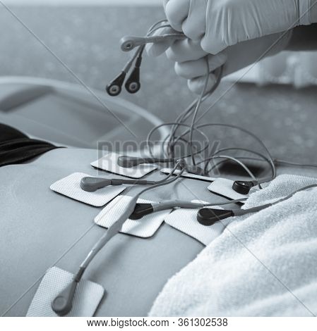 Fat Client Getting Myostimulation Procedure For Weight Loss In Beauty Salon