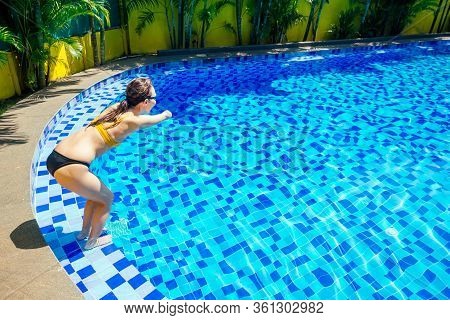 Happy Asian Armless Woman Warming Up Before Swimming At The Tropical Beach, She Jumps