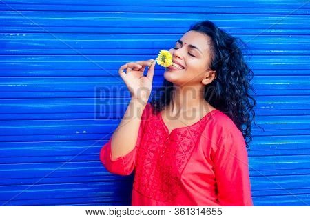 Attractive Beautiful Happy Young Latin Hispanic Woman With Teak Bindi On Forehead Smiling On Blue Wa