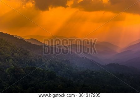Tropical Forest With Mountains And Majestic Orange Sky And Clouds. Camping Site At Maewong National 