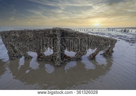 A Special Picture Of The Wreck Of Wierum With Spectacular Clouds, The Wadden Sea In Spring Condition