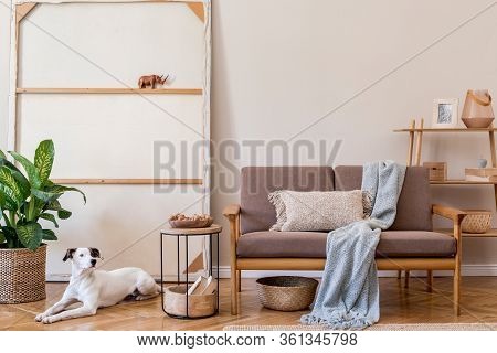 Interior Design Of Living Room With Stylish Brown Wooden Sofa, Macrame, Bookstand, Lamp, Coffee Tabl